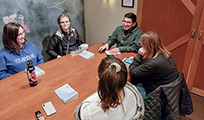 A group of trainees sitting around a table discussing a book during the trainee bookclub.